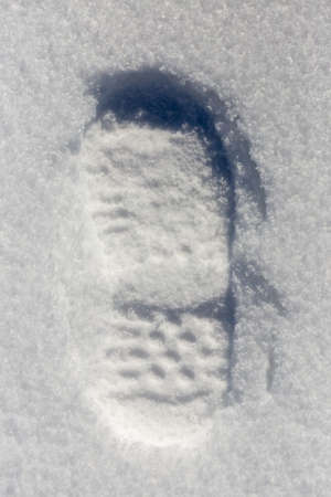 traces of shoes on a background of snowの写真素材