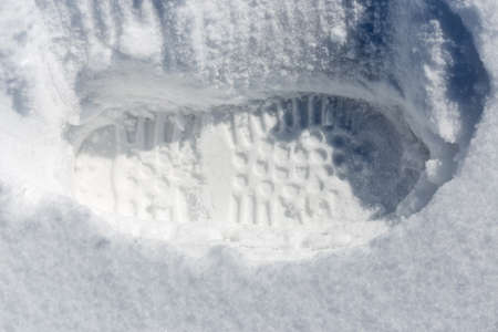 traces of shoes on a background of snowの写真素材