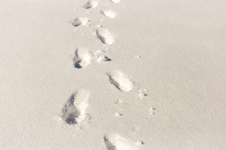 traces of shoes on a background of snowの写真素材