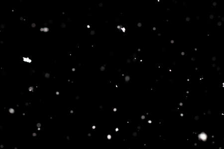Snowstorm texture. Bokeh lights on black background, shot of flying snowflakes in the airの写真素材