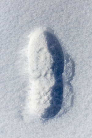 traces of shoes on a background of snowの写真素材