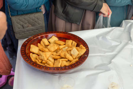 people celebrate the Kazakh holiday Nauryz. People distribute free national food, and many rush for food.の写真素材