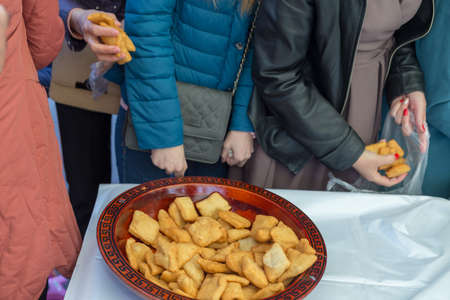 people celebrate the Kazakh holiday Nauryz. People distribute free national food, and many rush for food.の写真素材