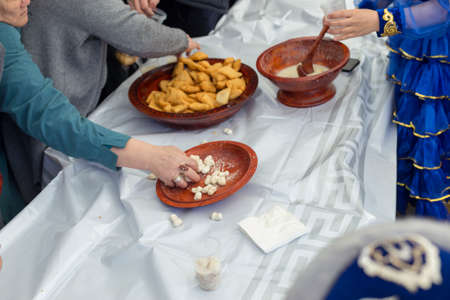 people celebrate the Kazakh holiday Nauryz. People distribute free national food, and many rush for food.の写真素材