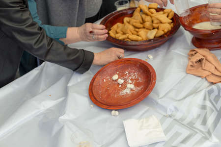 people celebrate the Kazakh holiday Nauryz. People distribute free national food, and many rush for food.の写真素材
