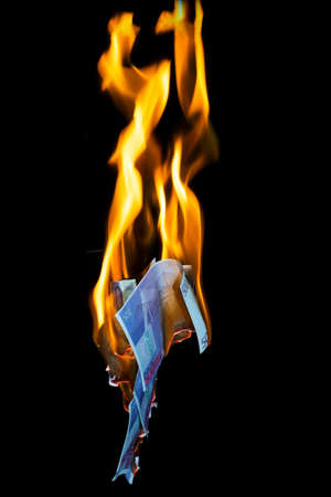 five hundred euro fakes are burning on a black backgroundの写真素材