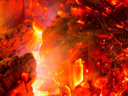 Bright sparkling coals with fire as backgroundの写真素材