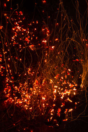 Bright sparkling coals with fire as backgroundの写真素材