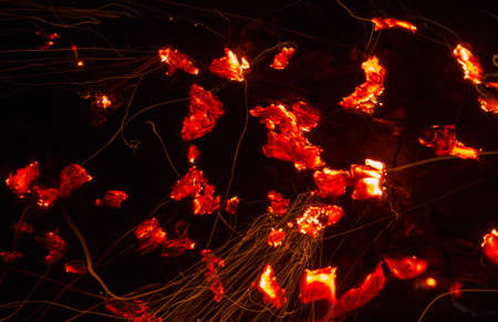 Bright sparkling coals with fire as backgroundの写真素材