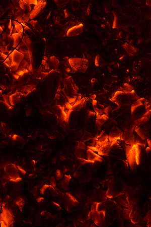 Bright sparkling coals with fire as backgroundの写真素材