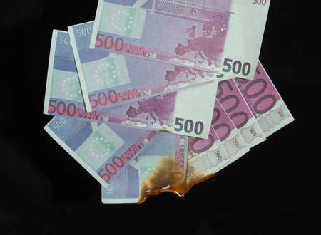 five hundred euro fakes are burning on a black backgroundの写真素材