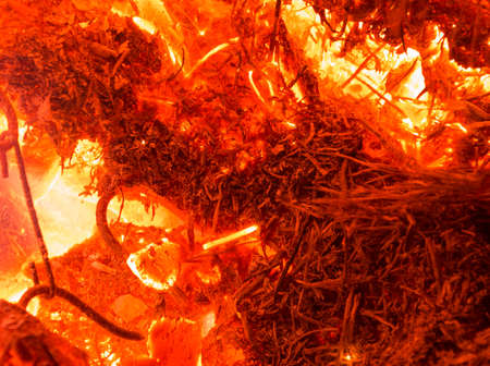 Bright sparkling coals with fire as backgroundの写真素材