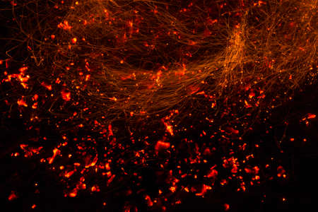 Bright sparkling coals with fire as backgroundの写真素材