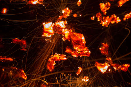 Bright sparkling coals with fire as backgroundの写真素材