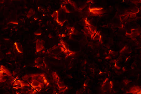 Bright sparkling coals with fire as backgroundの写真素材