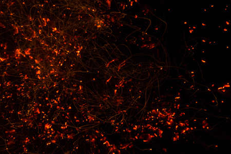 Bright sparkling coals with fire as backgroundの写真素材
