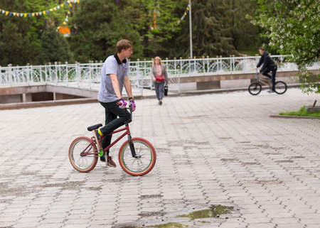 Almaty, Kazakhstan 04/17/2009. BMX biker shows bike stunts in the city parkのeditorial素材