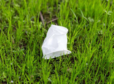 disposable plastic cup on the grassの写真素材