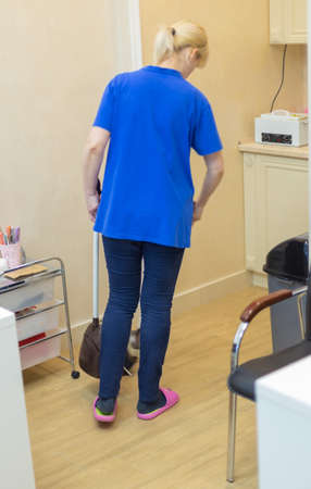 Woman holding a broom. Girls carry a brush with cleaning products. Woman preparing for cleaningの写真素材