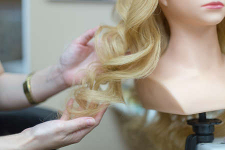 Training hairstyles on a mannequinの写真素材