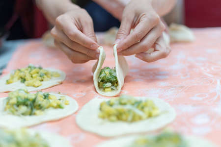 Woman cooks delicious pies (samsa)