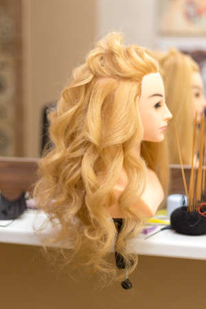 Training hairstyles on a mannequinの写真素材
