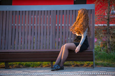 blonde sits on a benchの写真素材