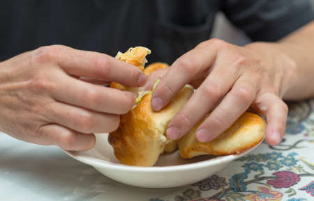 man eats hot cakes (samsa)の写真素材