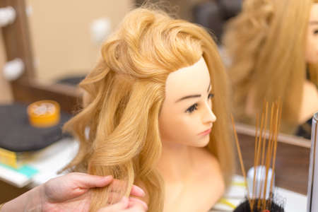 Training hairstyles on a mannequin