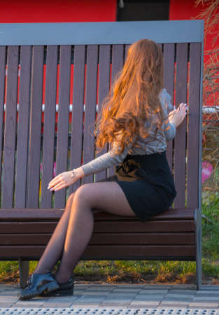 blonde sits on a benchの写真素材