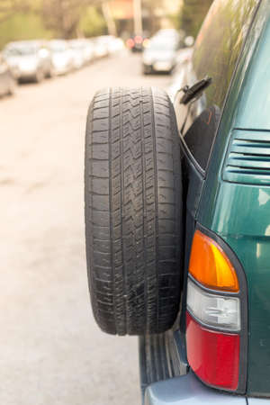 spare wheels or tires behind off road carの写真素材