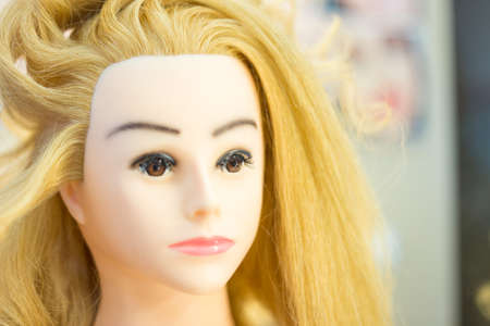 Training hairstyles on a mannequinの写真素材
