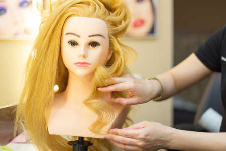 Training hairstyles on a mannequinの写真素材
