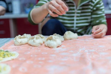 Woman cooks delicious pies (samsa)の写真素材