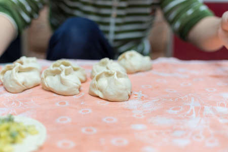 Woman cooks delicious pies (samsa)の写真素材