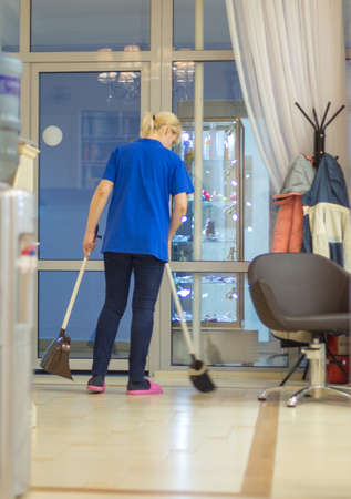Woman holding a broom. Girls carry a brush with cleaning products. Woman preparing for cleaningの写真素材