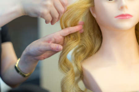 Training hairstyles on a mannequinの写真素材