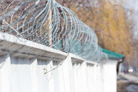 concrete fence with barbed wireの写真素材