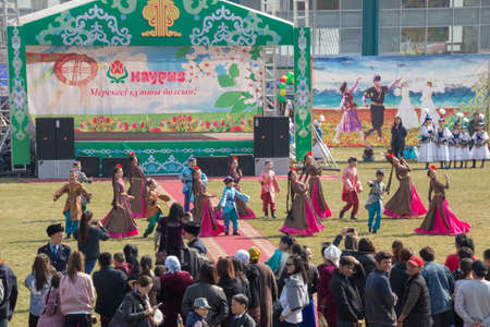 March 22, 2019 Almaty, Kazakhstan. Girls' groups dance in national costumes at the stadium during the celebration of the Nauryz holidayのeditorial素材