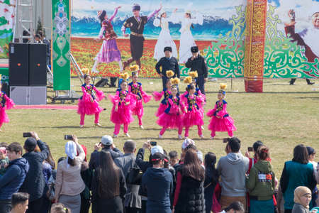 March 22, 2019 Almaty, Kazakhstan. Girls' groups dance in national costumes at the stadium during the celebration of the Nauryz holidayのeditorial素材