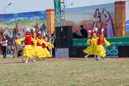 March 22, 2019 Almaty, Kazakhstan. Girls' groups dance in national costumes at the stadium during the celebration of the Nauryz holidayのeditorial素材