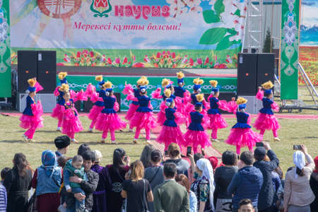 March 22, 2019 Almaty, Kazakhstan. Girls' groups dance in national costumes at the stadium during the celebration of the Nauryz holidayのeditorial素材