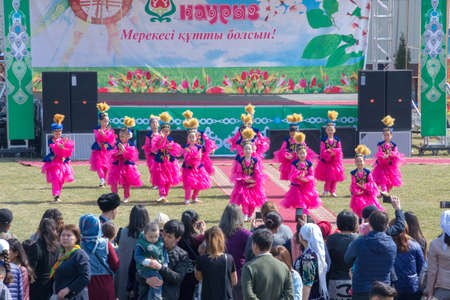 March 22, 2019 Almaty, Kazakhstan. Girls' groups dance in national costumes at the stadium during the celebration of the Nauryz holidayのeditorial素材