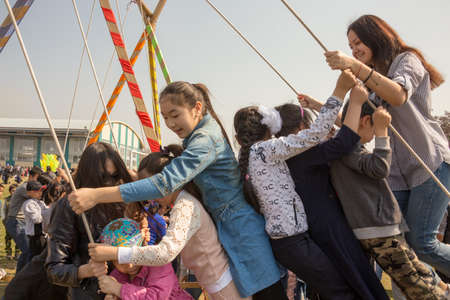 March 22, 2019 Almaty, Kazakhstan. Children playing during the celebration of Nauryz holidayのeditorial素材