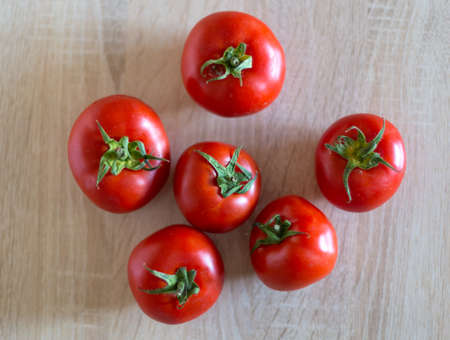 fresh tomatoes from the vegetable garden on white tableの写真素材