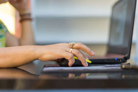 Close up of female hands use computer mountsの写真素材