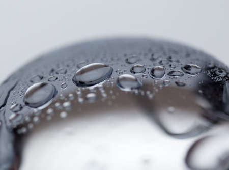 background, a drop of water on a shiny drain in the bathroom or on the sink close-upの写真素材