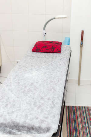 Massage room, massage couch with red pillowsの写真素材