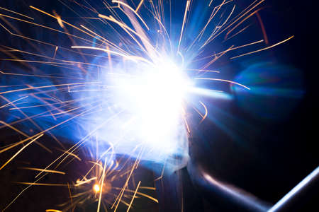 Welding sparks and smoke worker robotの写真素材