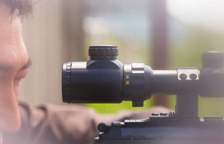 Close-up of a young man shooting. Sniper air rifle trainingの写真素材